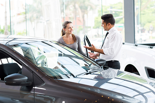 woman looking at new car